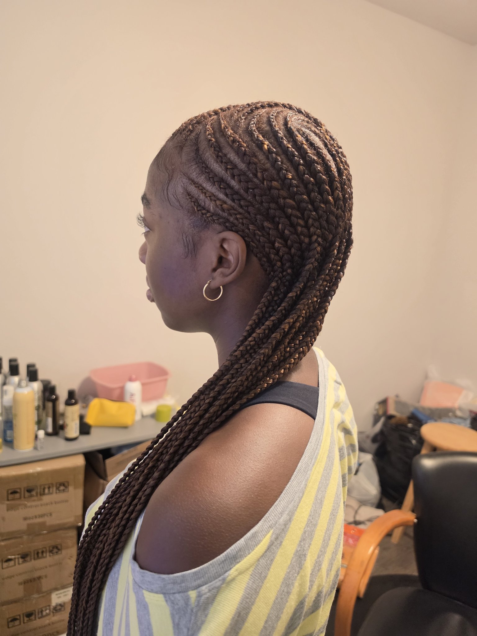 Feed-in cornrows in brown, side profile view