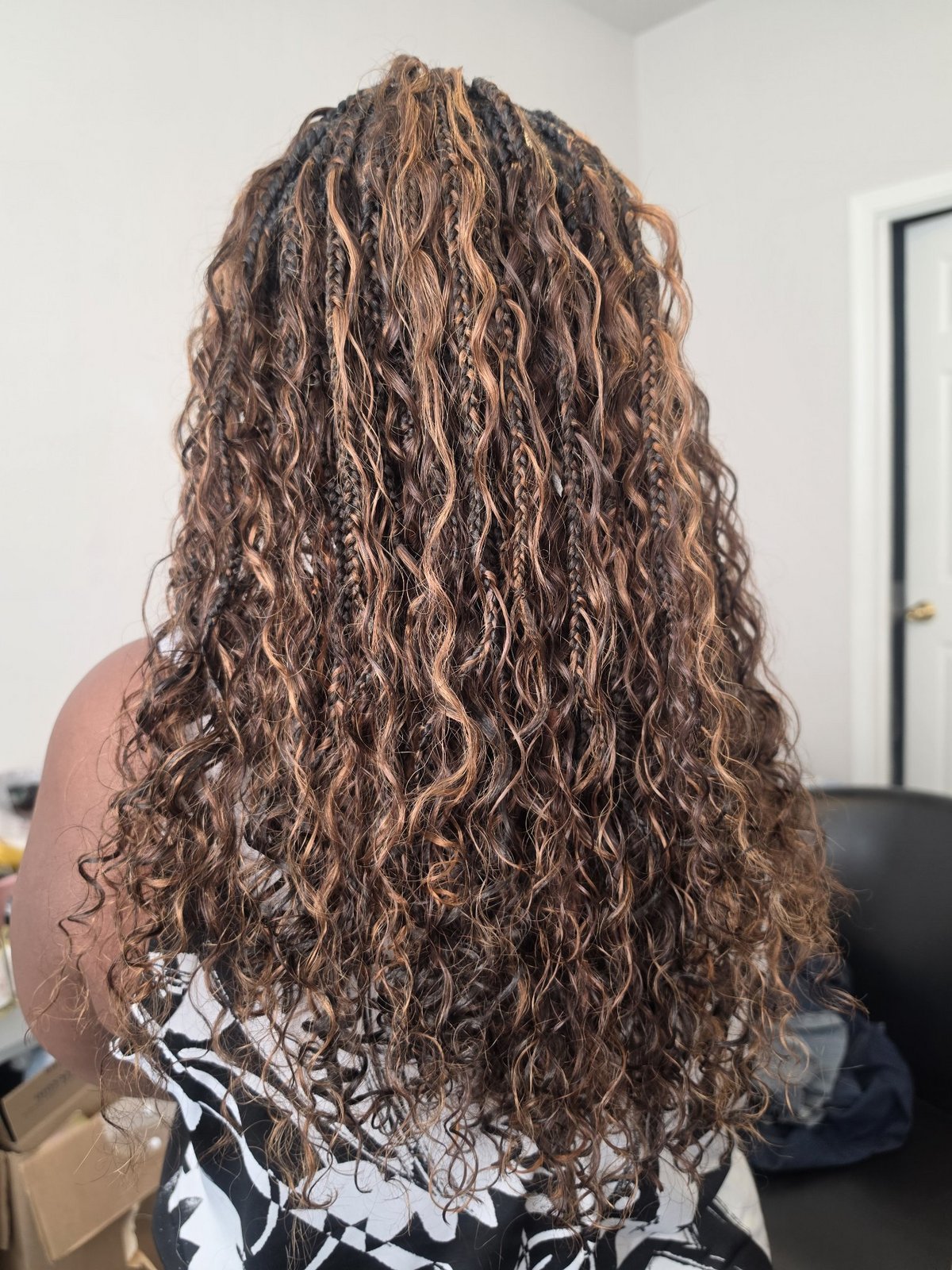 Boho box braids in a copper and dark brown blend with curly ends